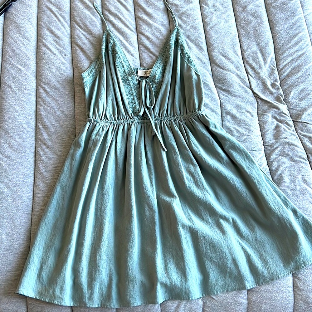 A green mini dress, adjustable straps